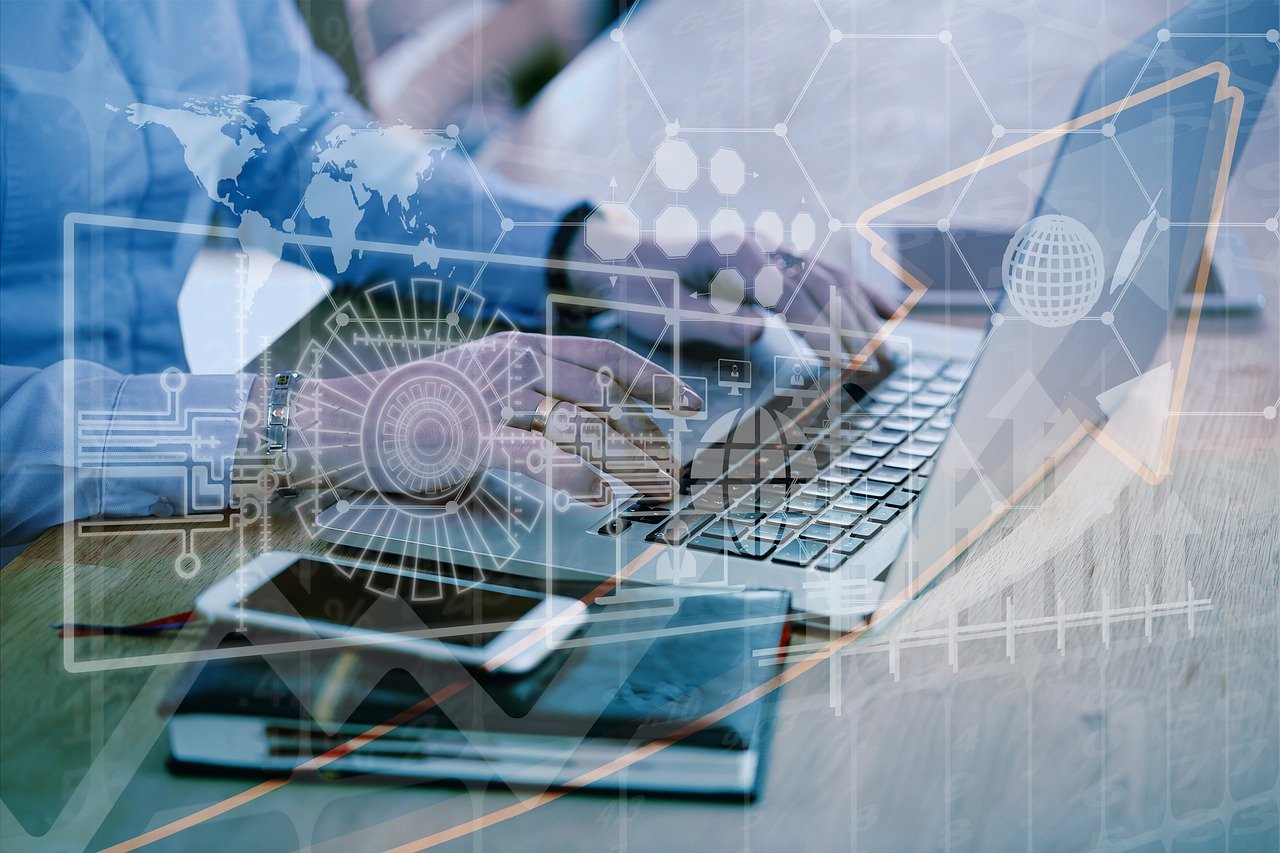 Business professional working on a laptop with futuristic digital overlays representing global connectivity, cybersecurity, and data analytics. Symbolizes digital transformation and technology-driven business growth.